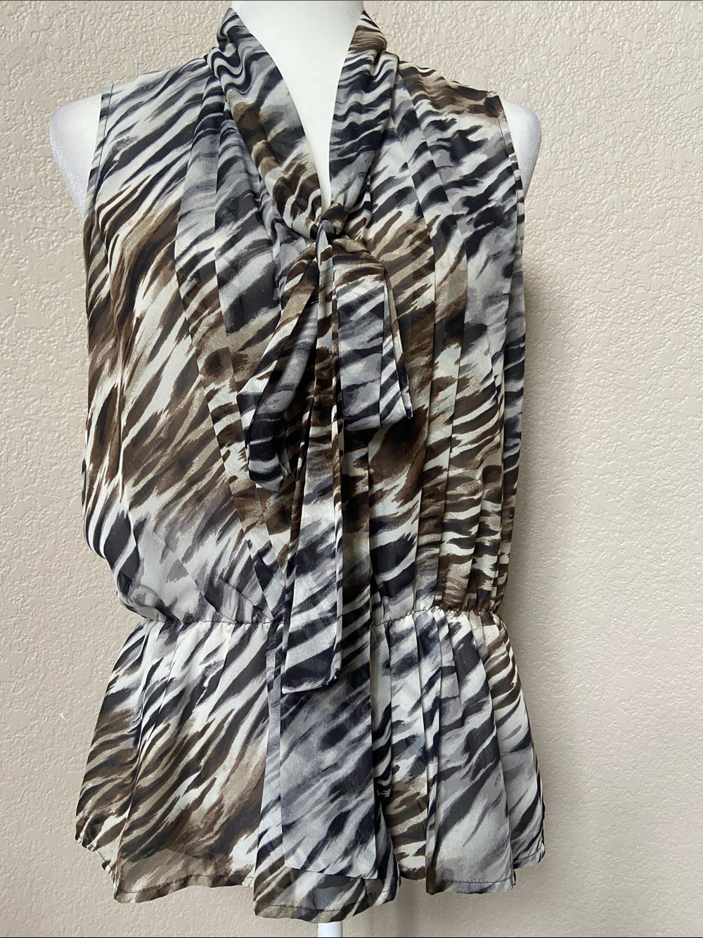 2/$15* Women’s Sleeveless Zebra-Print Peplum Top with tie-detail. Size M/8-10
